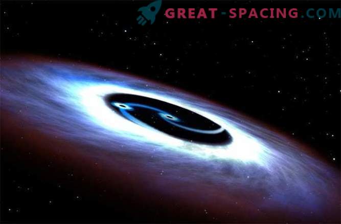 Buracos negros giram em torno de um quasar em uma batalha mortal